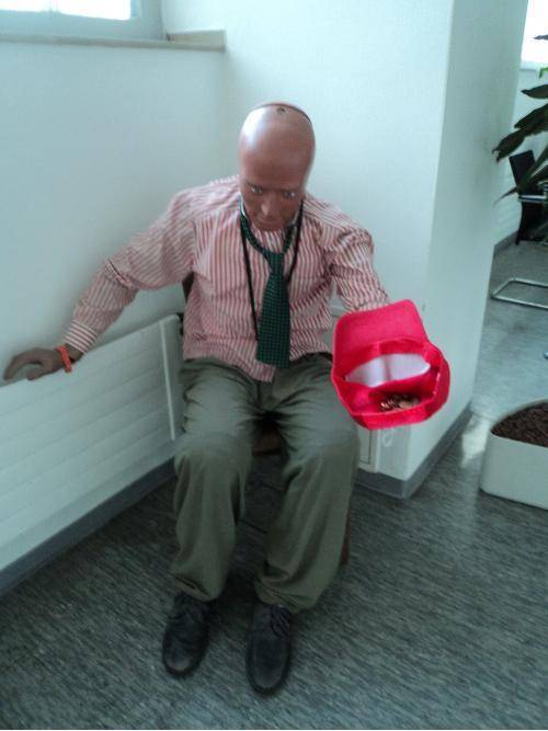 This fully dressed crash test dummy has been sitting in my office corridor for months. Recently, people have begun tipping him.