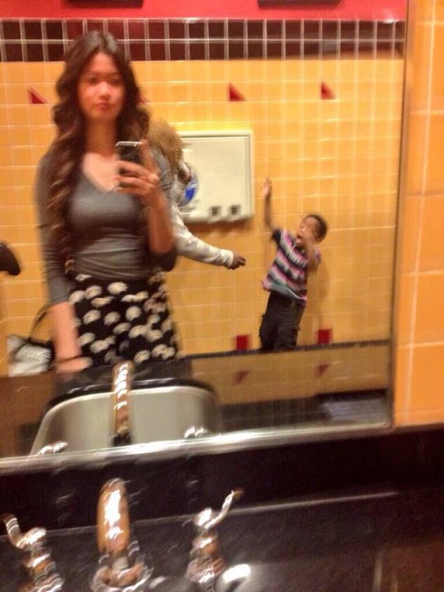 That awkward moment when you're trying to take a selfie and a mother decides to beat her child with her sandal