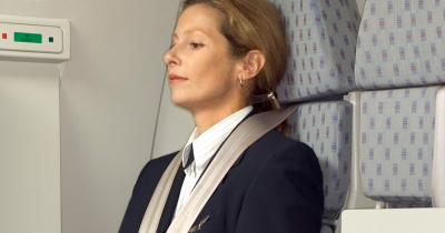 Why Flight Attendants Sit On Their Hands During Takeoff And Landing, According To Experts